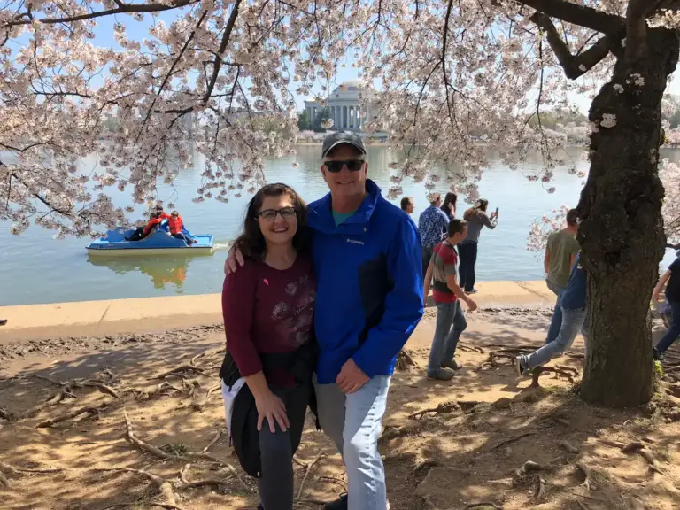 Matt and Linda standing under cherry blossoms at the Tidal Basin in Washington DC